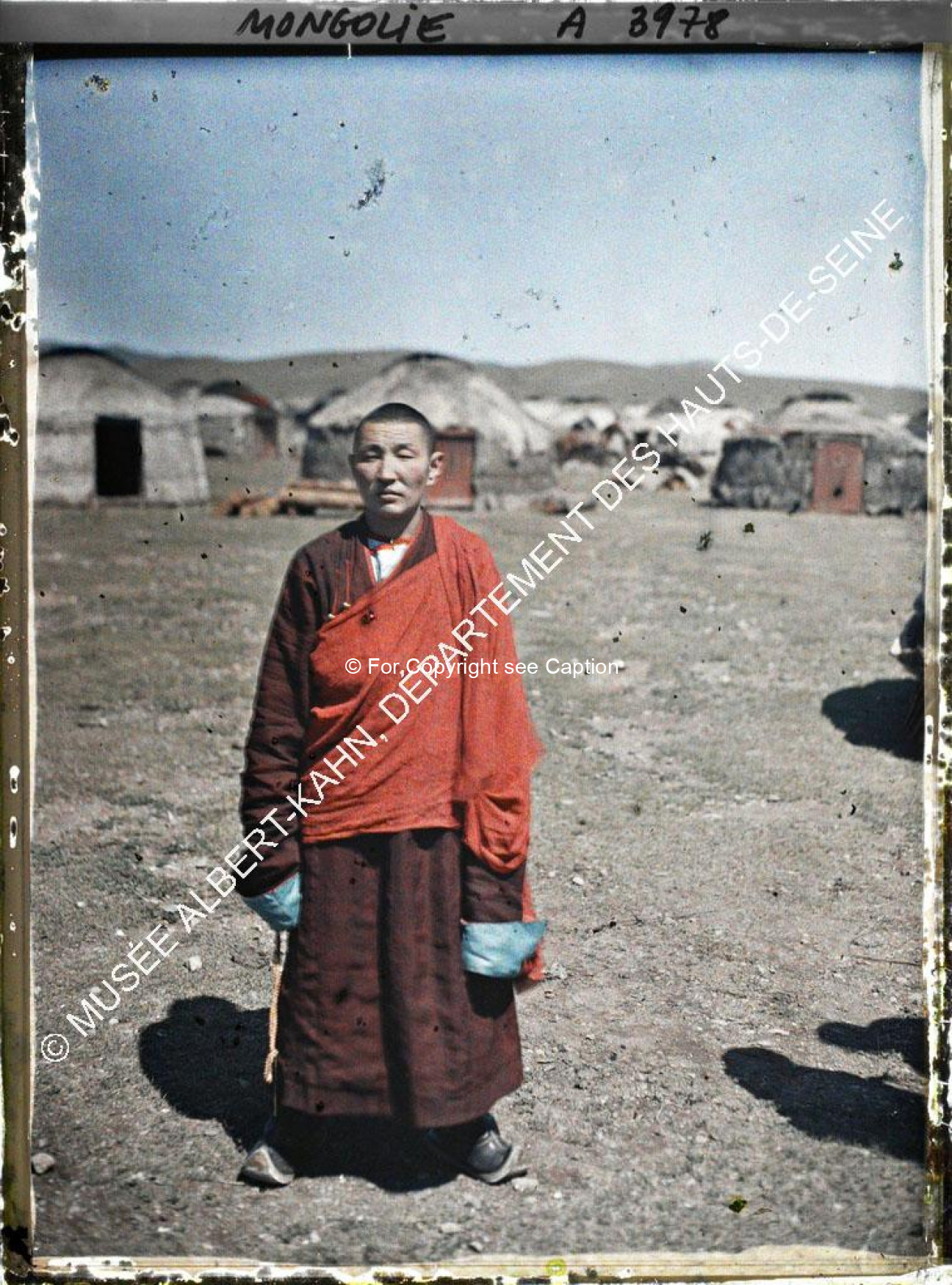 A monk standing in the area behind Gandan (?). Musée Albert-Kahn. A 3978. Photo by Stéphane Passet, 